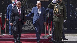 Palestinian President Mahmoud Abbas, right receives Jordan's King Abdullah II,