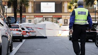 Police cars and tents block the road in Montreux where the victims died.