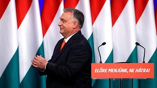 Hungarian Prime Minister Viktor Orban gestures after delivering his annual state of the nation speech, 12 February, 2022. Slogan reads "Let's go forwards, not backwards!"