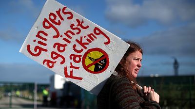 A protester stands outside Cuadrilla's Preston Road fracking site near Blackpool in 2018.