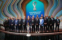 Coaches pose for a group photo following the 2022 soccer World Cup draw at the Doha Exhibition and Convention Center in Doha, Qatar, Friday, April 1, 2022.