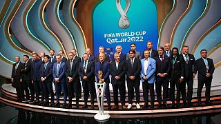 Coaches pose for a group photo following the 2022 soccer World Cup draw at the Doha Exhibition and Convention Center in Doha, Qatar, Friday, April 1, 2022.