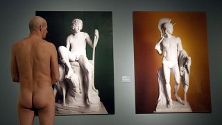 A naked museum visitor at the show "Nude Men from 1800 to Today" during a special opening to friends of nudism at the Leopold Museum, Vienna in 2013
