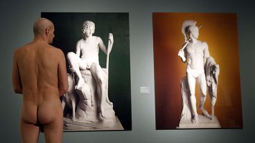 A naked museum visitor at the show "Nude Men from 1800 to Today" during a special opening to friends of nudism at the Leopold Museum, Vienna in 2013