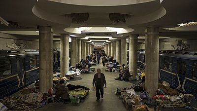 People stay in a metro station being used as a bomb shelter in Kharkiv.