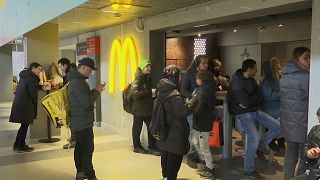 People queue inside a McDonald's restaurant at Moscow's Leningradsky train station.