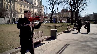 Violinist playing music on a street in Lviv