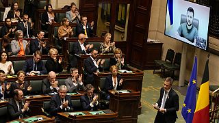 Belgium's Prime Minister Alexander De Croo walks off the podium as Ukraine's President Volodymyr Zelenskyy addresses Belgian MPs in Brussels, Thursday March 31 2022.