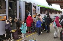 Ukrainian refugees wait on a platform at Przemysl railway station