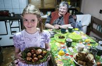 Ethnic Hungarian girl Jacinta Kosza shows Easter eggs after they were painted with boiled onion-skin in her home in Ineu, Transylvania, Romania, Saturday, April 19, 2019.