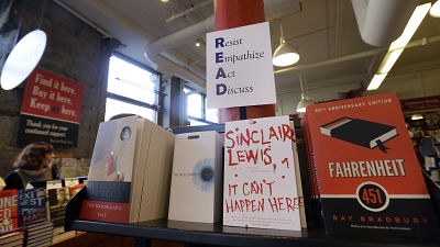 Books are displayed under a sign at the Harvard Book Store