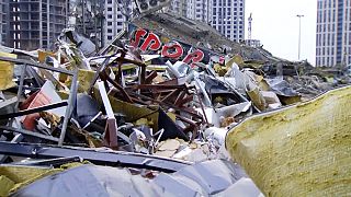 A huge field of rubble is overlooked by a devastated building that threatens to collapse. This is what is left of the Retroville shopping centre in Kyiv, Ukraine.