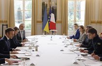French President Emmanuel Macron, left, speaks with mayor of the Ukrainian city of Melitopol, Ivan Fedorov, right, during a meeting at the Elysee Palace, in Paris, 1/4/2022.