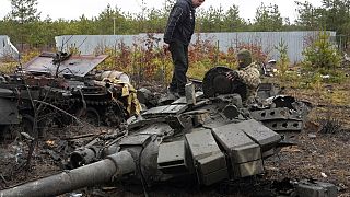 Un soldat ukrainien examine un char russe détruit dans le village de Dmytrivka près de Kyiv, Ukraine, samedi 2 avril 2022.