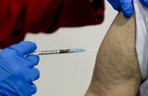 File photo shows a 87-year-old man getting his booster shot at the vaccination center in Frankfurt, Germany, Thursday, Nov. 11, 2021.