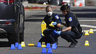 Sacramento Police crime scene investigators place evidence markers on 10th street at the scene of a mass shooting in Sacramento, Calif., on Sunday, April 3, 2022.
