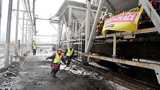 Protesters climb dockside cranes in Helsinki to stop a ship with coal from Russia from unloading, 5 April 2022
