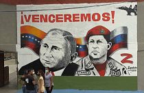 A smiling Vladimir Putin next to the deceased Hugo Chavez and a 'Z' for 'victory' are painted in a Caracas neighbourhood.