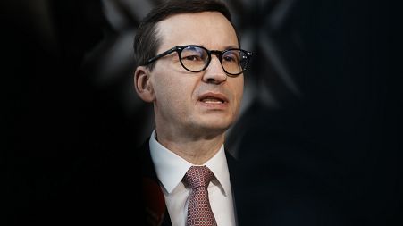 Poland's Prime Minister Mateusz Morawiecki speaks with the media as he arrives for an EU summit in March.