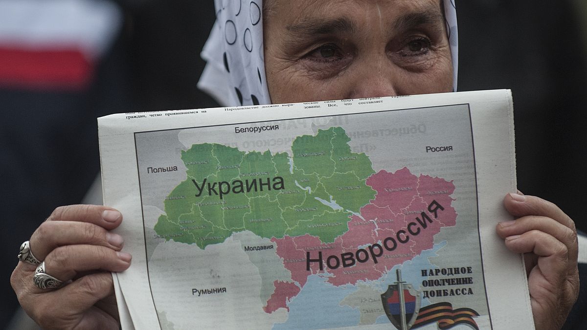 سيدة تحمل خريطة حيث تبدو "نوفاراسيا" أو "روسيا الجديدة" باللون الأحمر، وهي تقسم أوكرانيا 