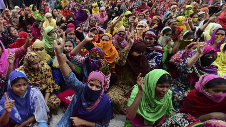 Bangladeshi garment workers block a road during a demonstration to demand higher wages, in Dhaka.