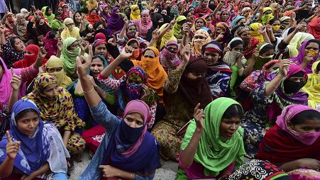 Bangladeshi garment workers block a road during a demonstration to demand higher wages, in Dhaka.