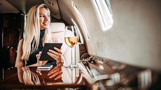 An influencer sits on a plane