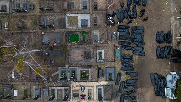 Policemen work to identify civilians who were killed during the Russian occupation in Bucha, Ukraine, on the outskirts of Kyiv