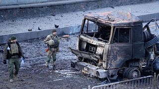 Ukrainian troops inspect the site following a Russian airstrike in Kyiv, Ukraine, Feb. 26, 2022