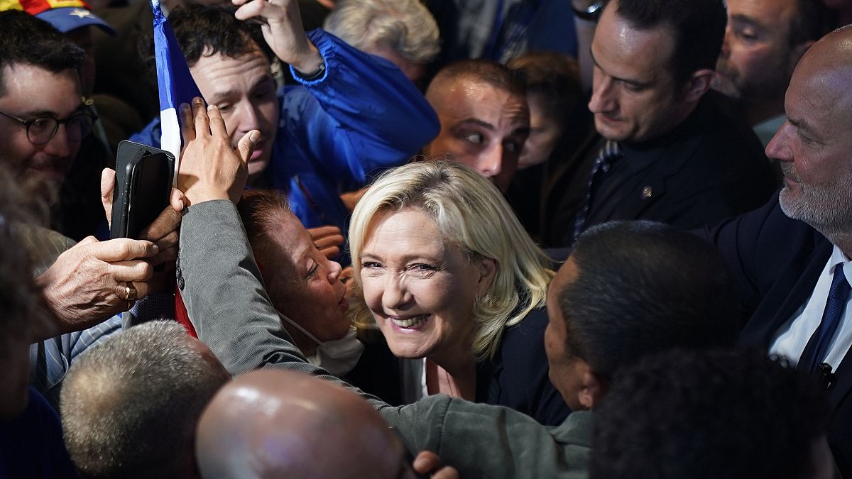 French far-right leader Marine Le Pen smiles to supporters during a campaign rally in Perpignan, southern France, Thursday, April 7, 2022.