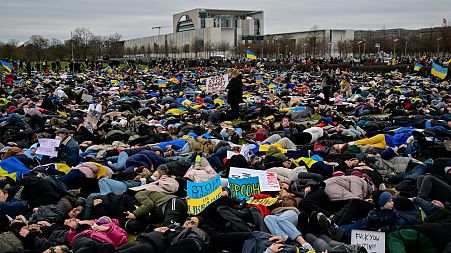 Pro-Ukrainian activists stage a "Die-in" during a protest under the slogan "Stop promising, start acting!" to call for an embargo on oil, gas and coal imports from Russia.