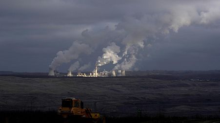 Steam and smoke rise from power plant located by the Turow lignite coal mine near the town of Bogatynia, Poland.