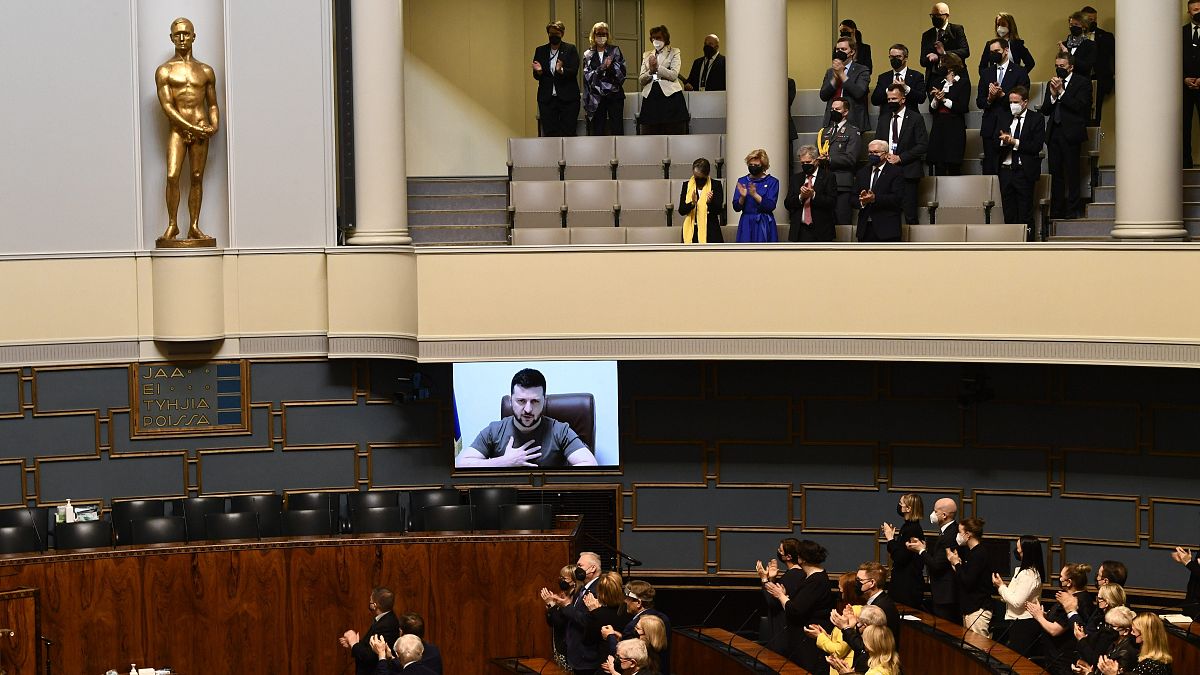 Finnish MP's listen to Ukrainian President Volodymyr Zelenskyy during his virtual address on Friday.