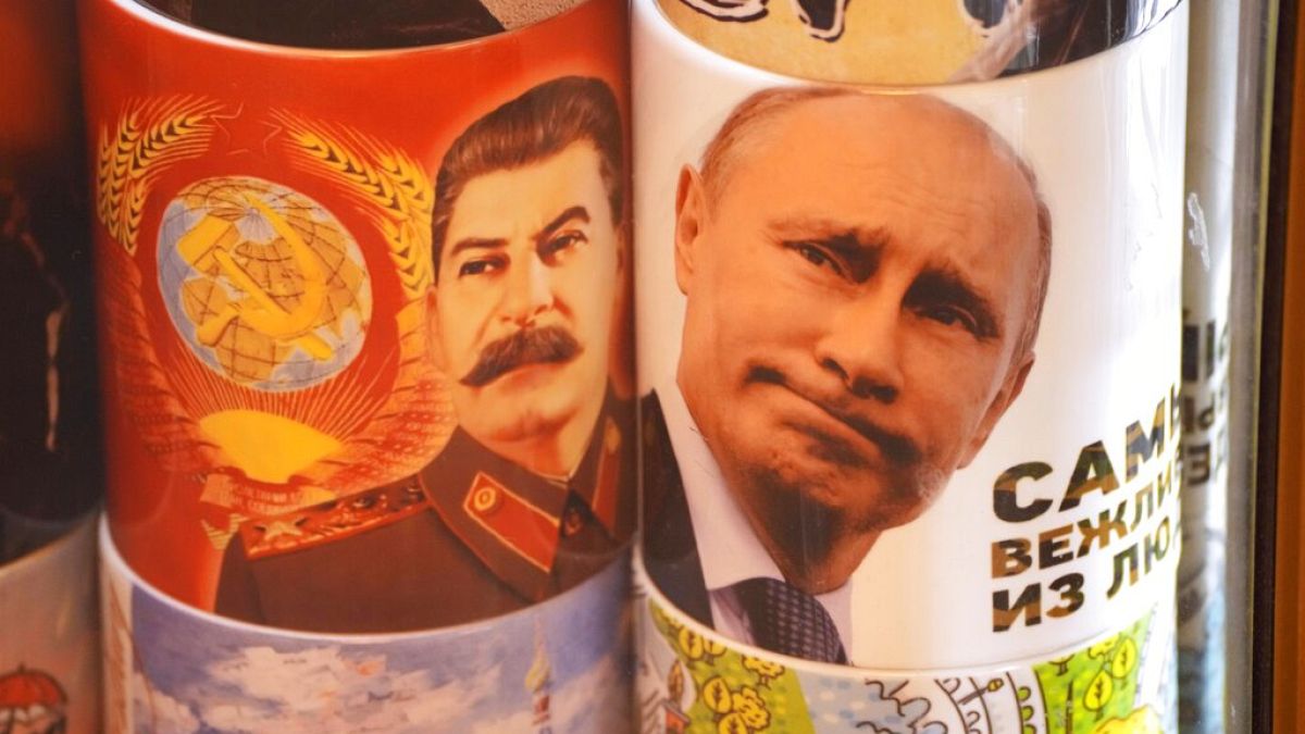 Cups depicting Soviet dictator Josef Stalin and Russian President Vladimir Putin are displayed for sale at a souvenir shop in St. Petersburg