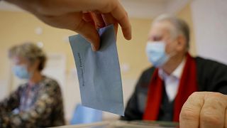 A woman casts her vote in the first round of the French presidential election, in Selestat, eastern France Sunday, 10 April, 2022.