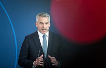 Austria's Chancellor Karl Nehammer attends a news conference with German Chancellor Olaf Scholz after a meeting at the chancellery in Berlin, Germany, Thursday, March 31, 2022