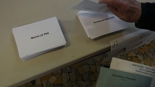 A voter prepares to vote in Paris, France, Sunday, April 24, 2022.