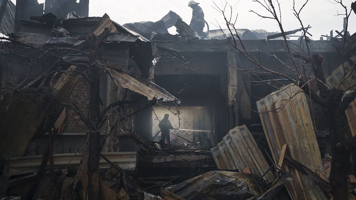 Firefighters work to extinguish a fire at a house after a Russian attack in Kharkiv, Ukraine, Monday, April 11, 2022.