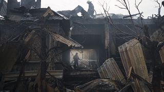 Firefighters work to extinguish a fire at a house after a Russian attack in Kharkiv, Ukraine, Monday, April 11, 2022.