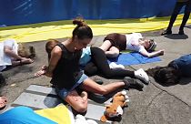 Demonstrators lying on the ground representing the victims in Ukraine