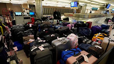 Baggage building up at an American airport last year. Similar scenes have occurred at Manchester and Heathrow airports over the last week.