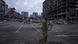 Soldier walks amid destruction in Kyiv