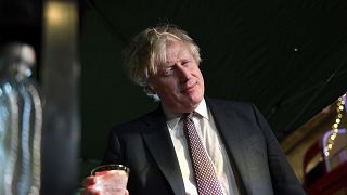 Boris Johnson samples an Isle of Harris gin as he visits a UK Food and Drinks market, set up in Downing Street, London, Tuesday Nov. 30, 2021