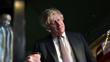Boris Johnson samples an Isle of Harris gin as he visits a UK Food and Drinks market, set up in Downing Street, London, Tuesday Nov. 30, 2021