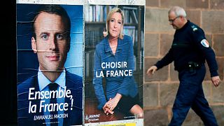 Election campaign posters for Emmanuel Macron, left, and Marine Le Pen, in Saint Jean Pied de Port, southwestern France, Friday May 5, 2017. 