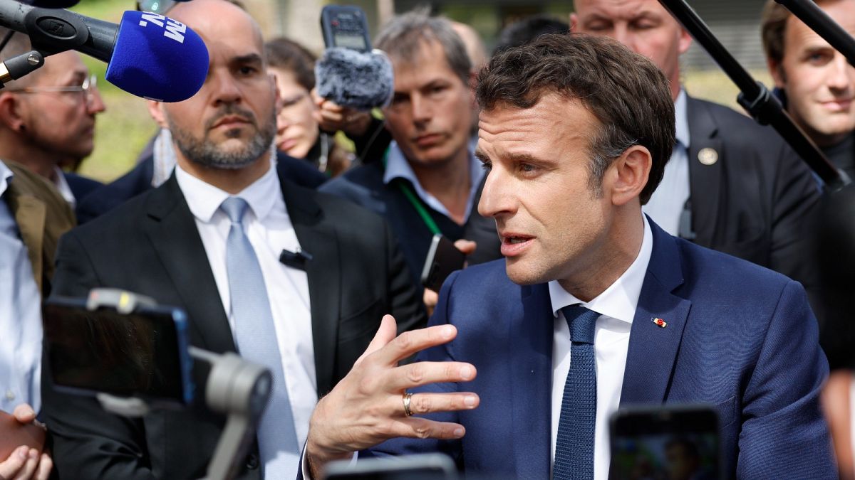 Emmanuel Macron speaks with supporters and medical staff in Mulhouse eastern France, Tuesday, 12 April 2022