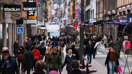 People visit one of Stockholm's busiest shopping streets on February 4, 2022.