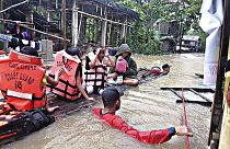 Des résidents sont évacués par des sauveteurs dans un village inondé à Panitan, sur l'île de Panay, (Philippines) le mardi 12 avril 2022.