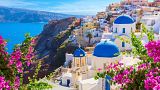 Oia town, Santorini island, with its traditional white houses and blue-domed churches. Oia town, Santorini island, with its traditional white houses and blue-domed churches.
