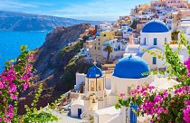 Oia town, Santorini island, with its traditional white houses and blue-domed churches. 